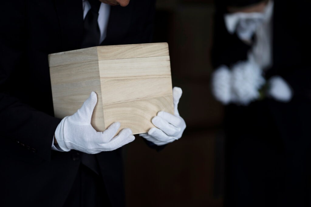 Bereaved holding urn at funeral